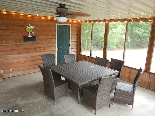 unfurnished sunroom featuring ceiling fan