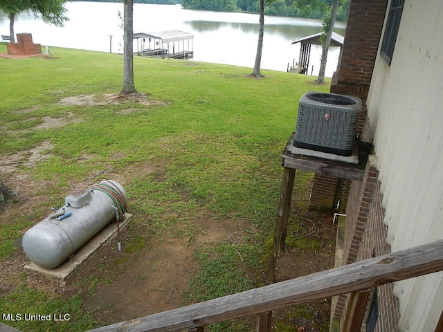 view of yard featuring cooling unit and a water view