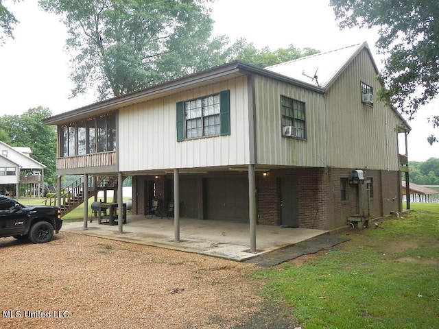 back of house with a sunroom and a carport