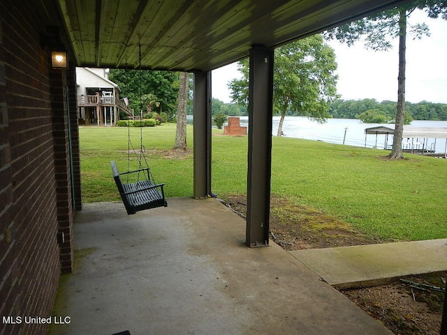 view of yard with a patio area and a water view