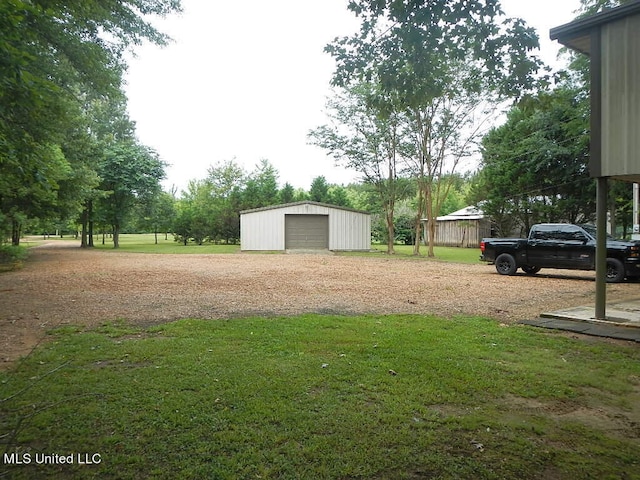 view of yard with an outdoor structure and a garage