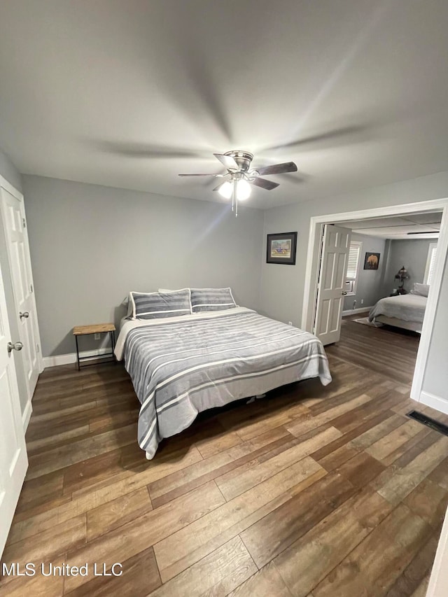 bedroom featuring ceiling fan and dark hardwood / wood-style floors