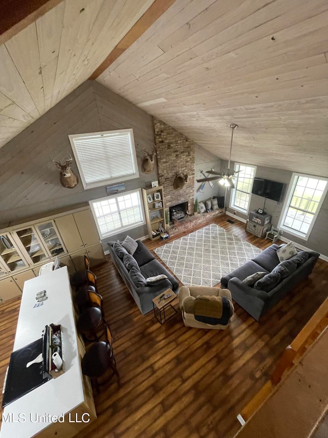 living room featuring a fireplace, hardwood / wood-style floors, ceiling fan, wooden ceiling, and high vaulted ceiling