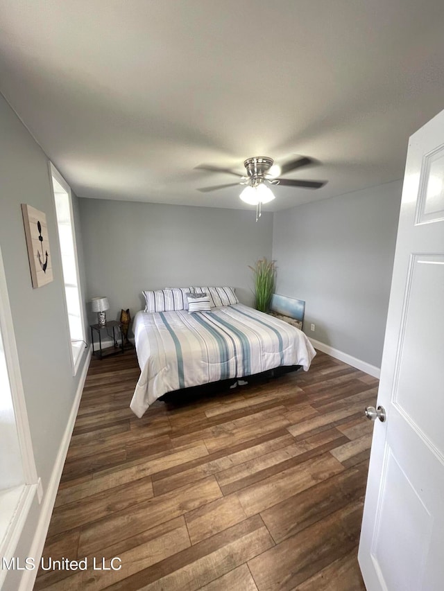 bedroom with dark wood-type flooring and ceiling fan