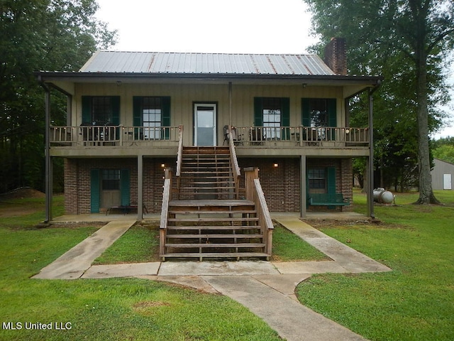 view of front of home with a front yard and a porch