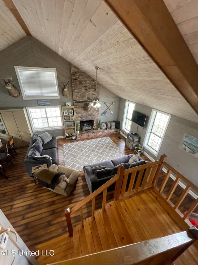 living room featuring hardwood / wood-style flooring, high vaulted ceiling, a wealth of natural light, and a brick fireplace