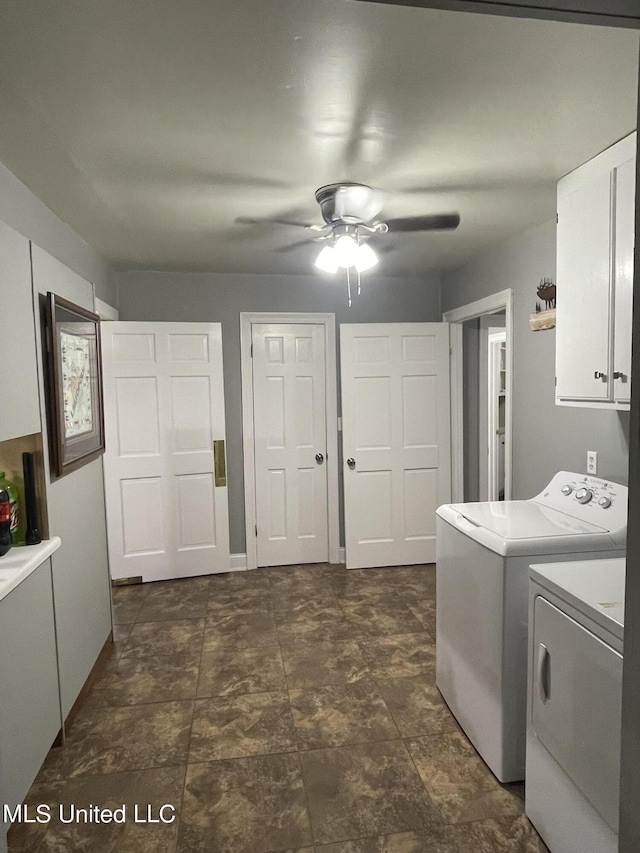 washroom with ceiling fan, cabinet space, and washer and clothes dryer
