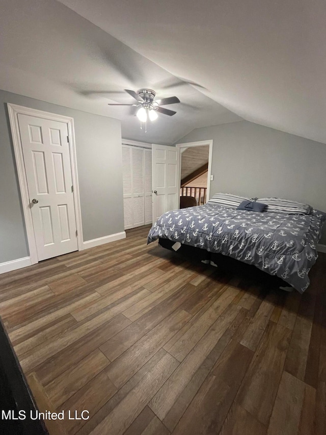 bedroom with lofted ceiling, hardwood / wood-style floors, a closet, and ceiling fan