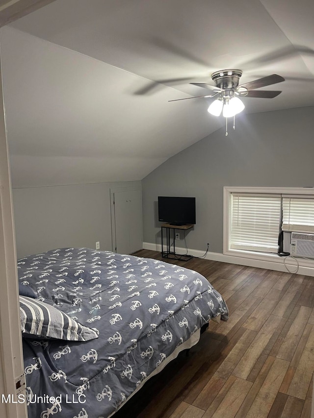 bedroom with dark wood-type flooring, vaulted ceiling, and ceiling fan