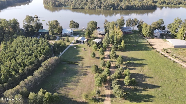 bird's eye view featuring a wooded view and a water view