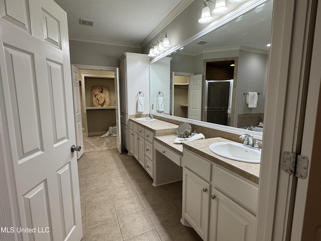 bathroom featuring vanity, crown molding, a shower with shower door, and tile patterned floors