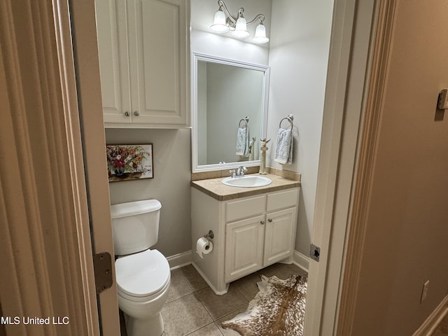 bathroom with vanity, tile patterned floors, and toilet