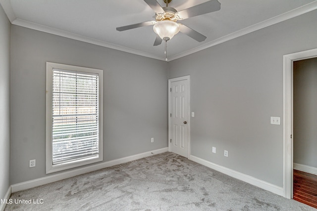 unfurnished room featuring ceiling fan, ornamental molding, and light colored carpet