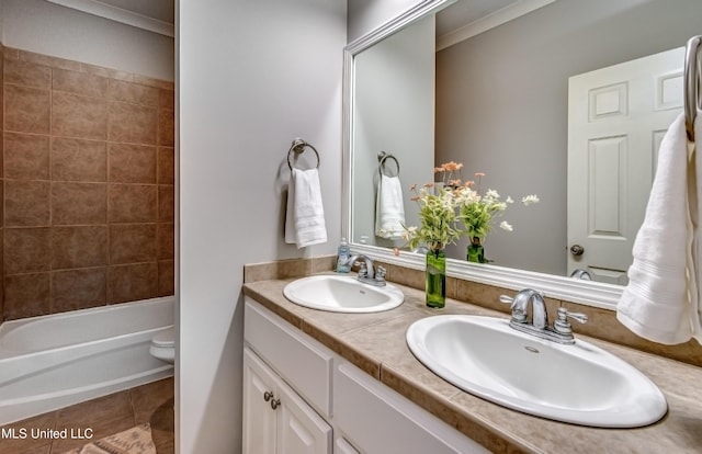 full bathroom featuring tile patterned floors, toilet, tiled shower / bath combo, and vanity