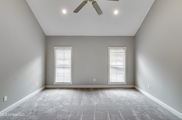 unfurnished room with lofted ceiling, light colored carpet, and ceiling fan