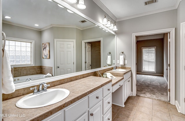 bathroom with tile patterned flooring, vanity, ornamental molding, and a bath