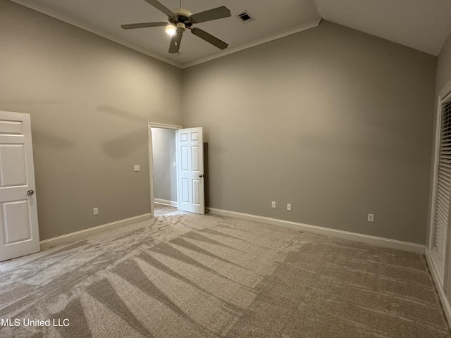 carpeted spare room with high vaulted ceiling and ceiling fan