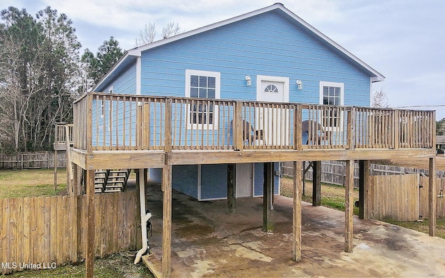 rear view of house featuring a wooden deck and a carport