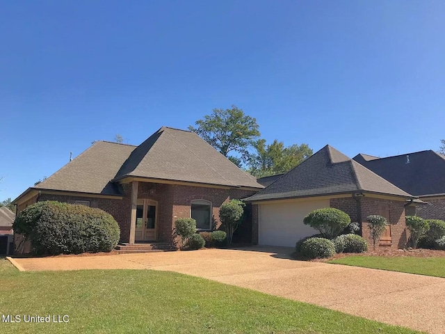 view of front of house featuring a garage and a front lawn