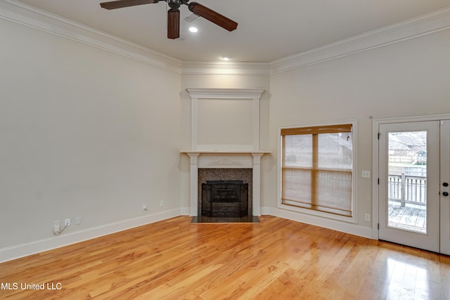 unfurnished living room with french doors, light hardwood / wood-style floors, ceiling fan, and crown molding