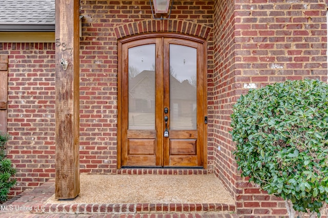 537 Turtle Ln, Brandon, MS 39047 - property entrance featuring brick siding, a shingled roof, and french doors