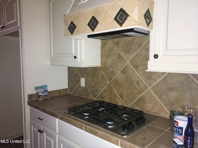 kitchen with black gas cooktop, tile counters, white cabinets, and custom exhaust hood