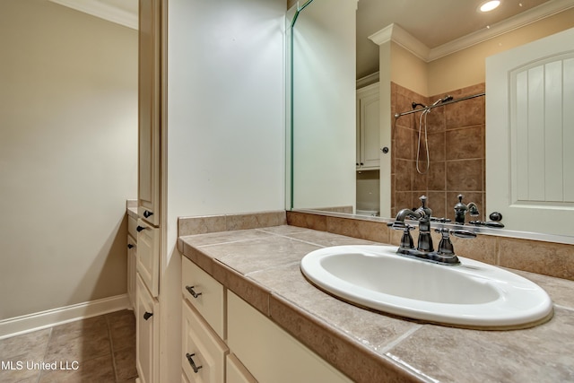 bathroom featuring tile patterned flooring, a tile shower, vanity, and crown molding