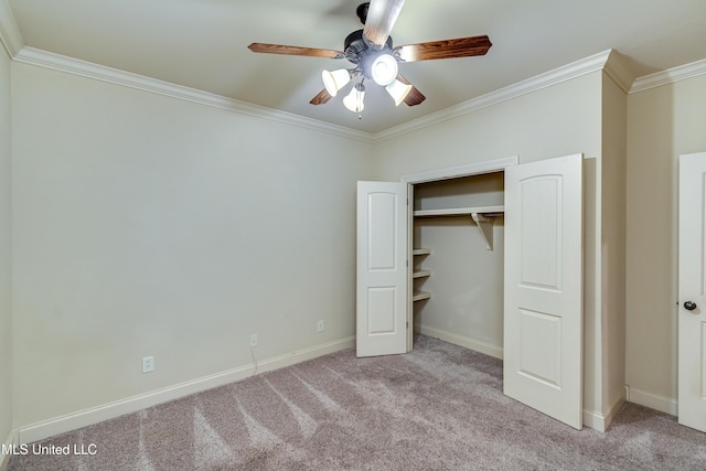 unfurnished bedroom featuring a closet, ceiling fan, crown molding, and light colored carpet