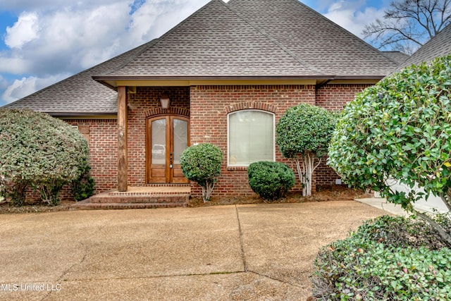537 Turtle Ln, Brandon, MS 39047 - view of front of house featuring a shingled roof, brick siding, and french doors