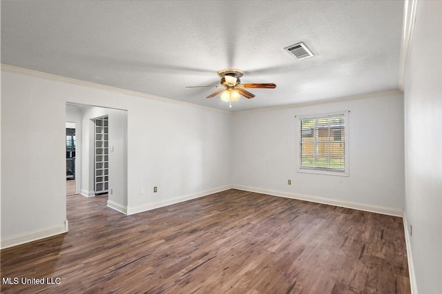 spare room featuring a textured ceiling, crown molding, and dark hardwood / wood-style floors