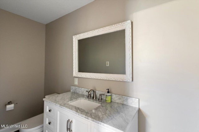 bathroom with toilet and vanity