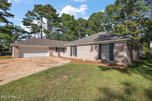 ranch-style house featuring a front lawn and a garage