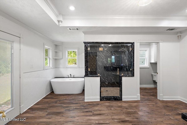 bathroom with crown molding, a textured ceiling, separate shower and tub, and hardwood / wood-style floors