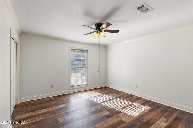 spare room with crown molding, dark hardwood / wood-style floors, and ceiling fan