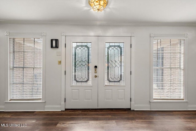 entryway with crown molding, dark hardwood / wood-style floors, and french doors