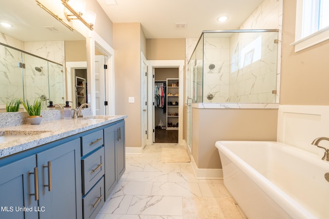 bathroom featuring vanity, a healthy amount of sunlight, and plus walk in shower