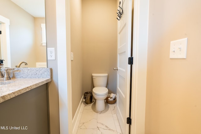 bathroom featuring toilet and vanity