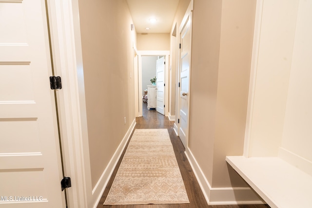 hallway with dark hardwood / wood-style flooring