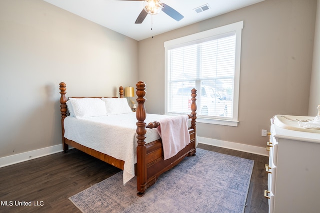 bedroom with ceiling fan and dark hardwood / wood-style floors