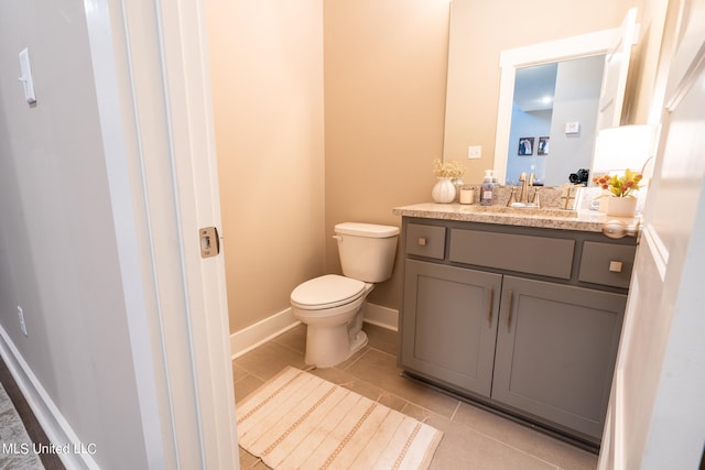 bathroom featuring toilet, vanity, and tile patterned floors