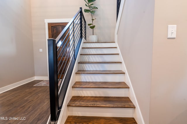 stairway featuring wood-type flooring