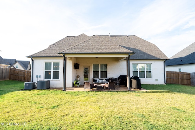 rear view of property featuring outdoor lounge area, a yard, cooling unit, and a patio area