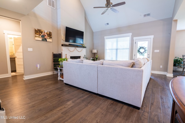 living room featuring dark hardwood / wood-style floors, high vaulted ceiling, and ceiling fan