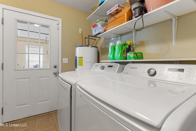 laundry room featuring tile patterned flooring, laundry area, water heater, and washer and clothes dryer