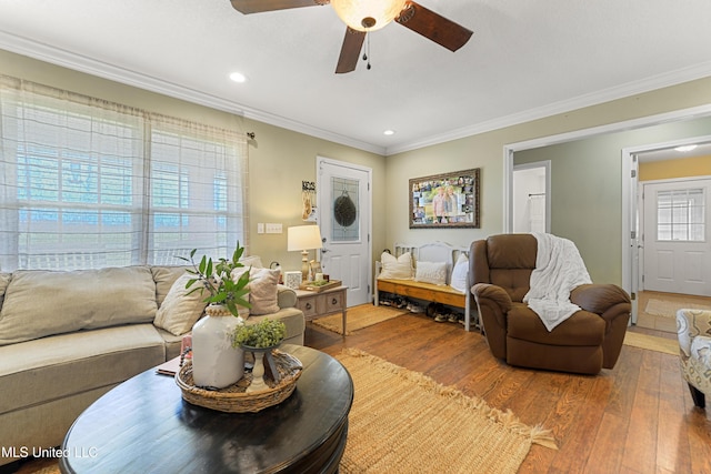 living room with recessed lighting, hardwood / wood-style floors, a ceiling fan, and ornamental molding