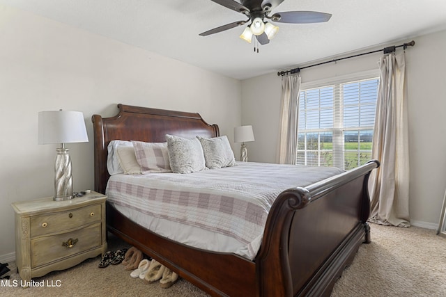 carpeted bedroom with baseboards and a ceiling fan