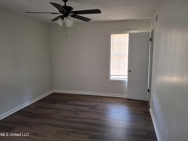 empty room featuring ceiling fan and dark hardwood / wood-style floors