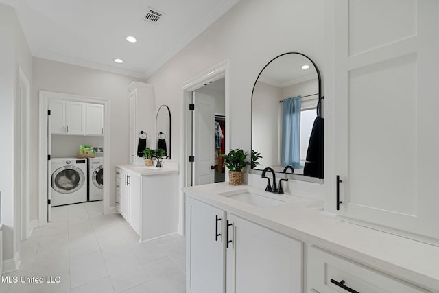 bathroom featuring tile patterned floors, ornamental molding, washer and dryer, and vanity