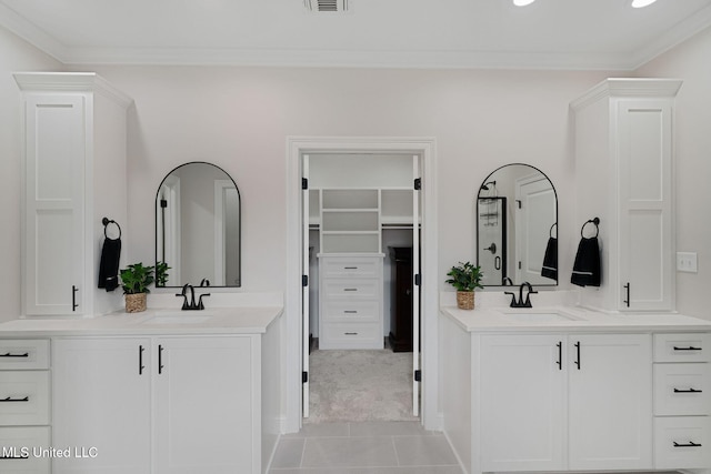 bathroom featuring tile patterned floors, ornamental molding, and vanity