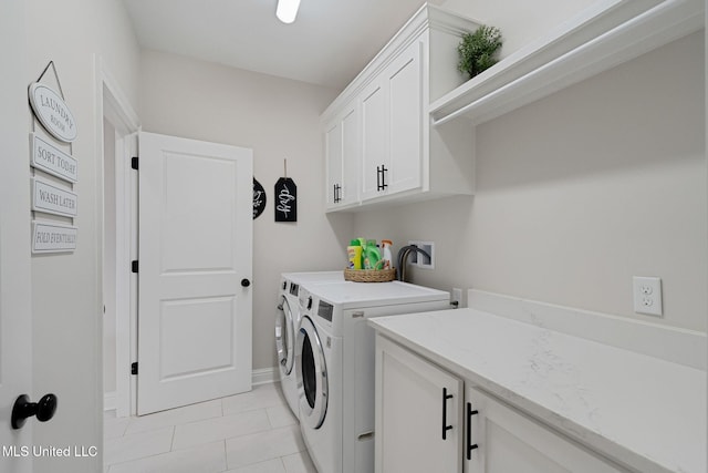 washroom with cabinets, light tile patterned flooring, and separate washer and dryer